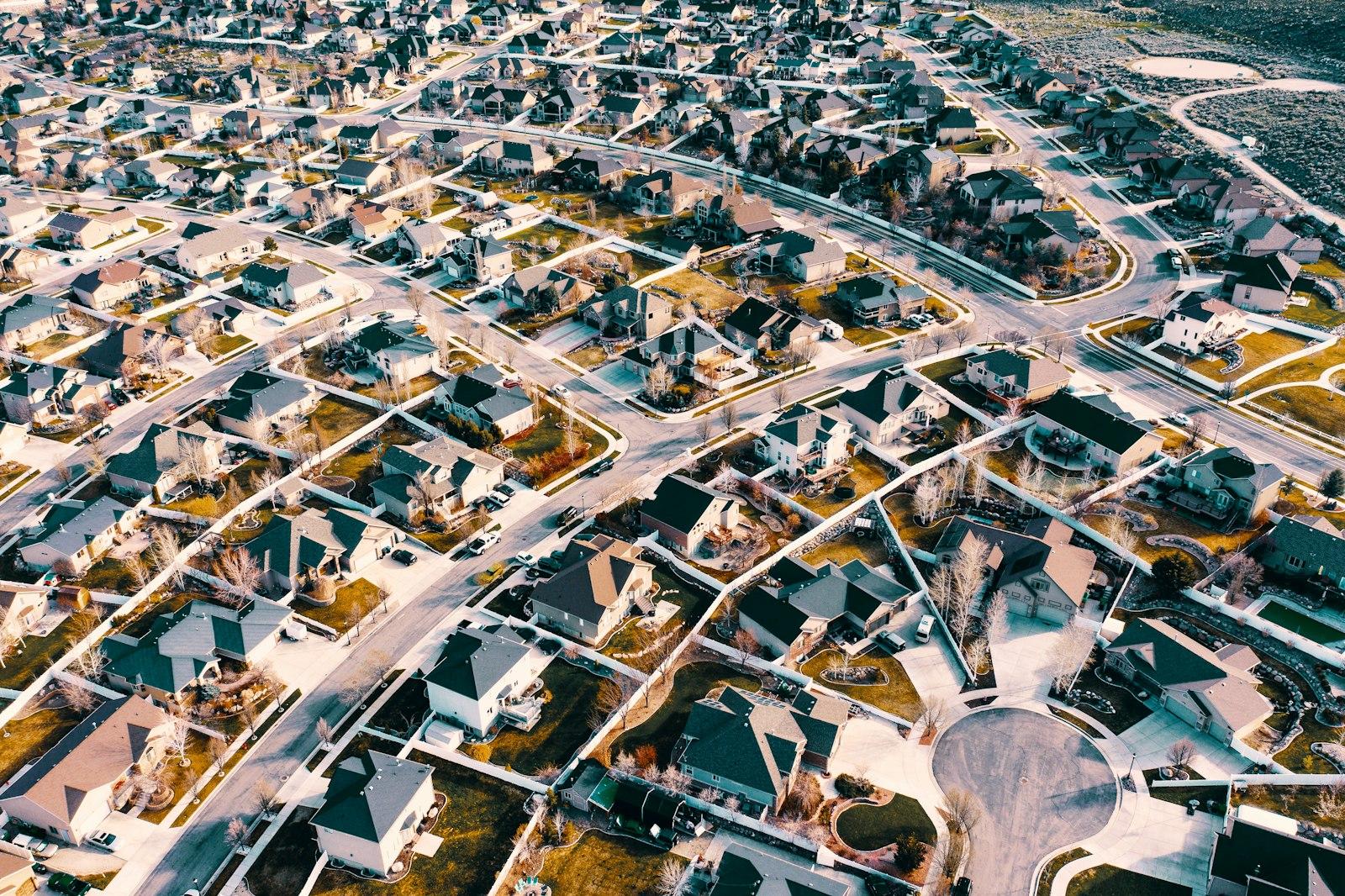 Aerial satellite view of a suburban neighborhood with many rooftops